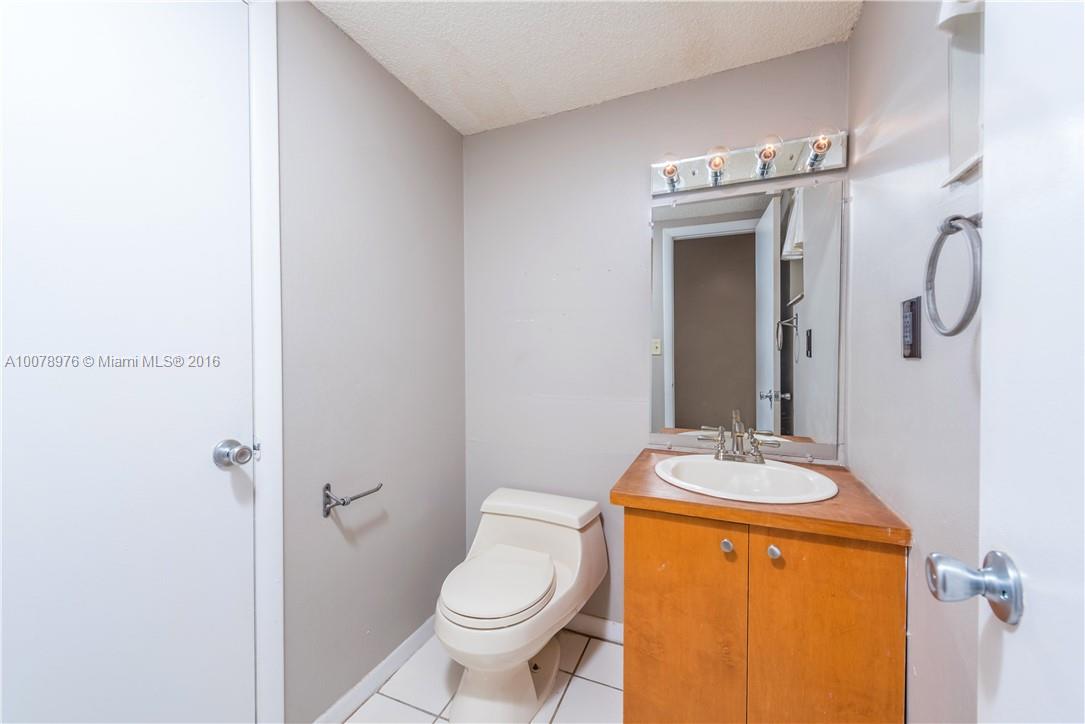 8375 Southwest 137th Avenue, Unit 8375 Miami, FL 33183 - Photo 28 of 30 a bathroom with a granite countertop sink toilet and shower