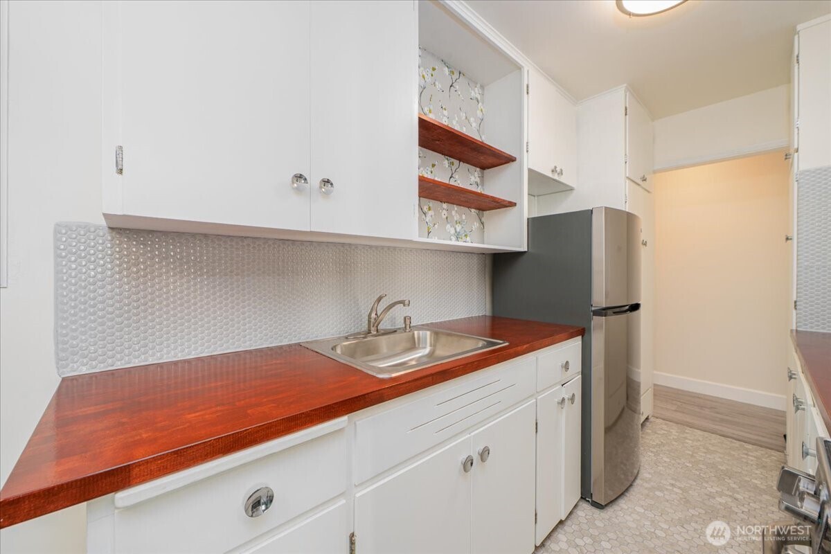 7 Harrison Street, Unit 20 Seattle, WA 98109 - Photo 11 of 27 a kitchen with a sink and a refrigerator