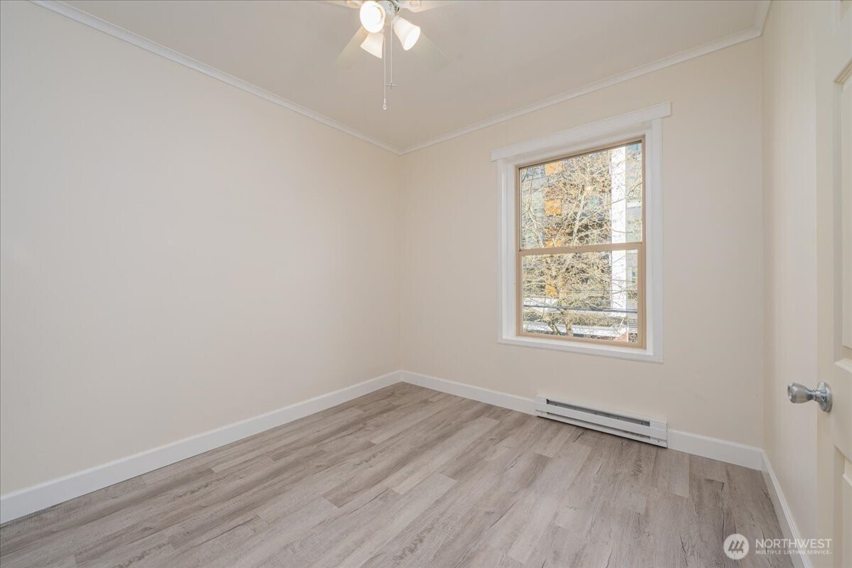 7 Harrison Street, Unit 20 Seattle, WA 98109 - Photo 13 of 27 an empty room with wooden floor and windows