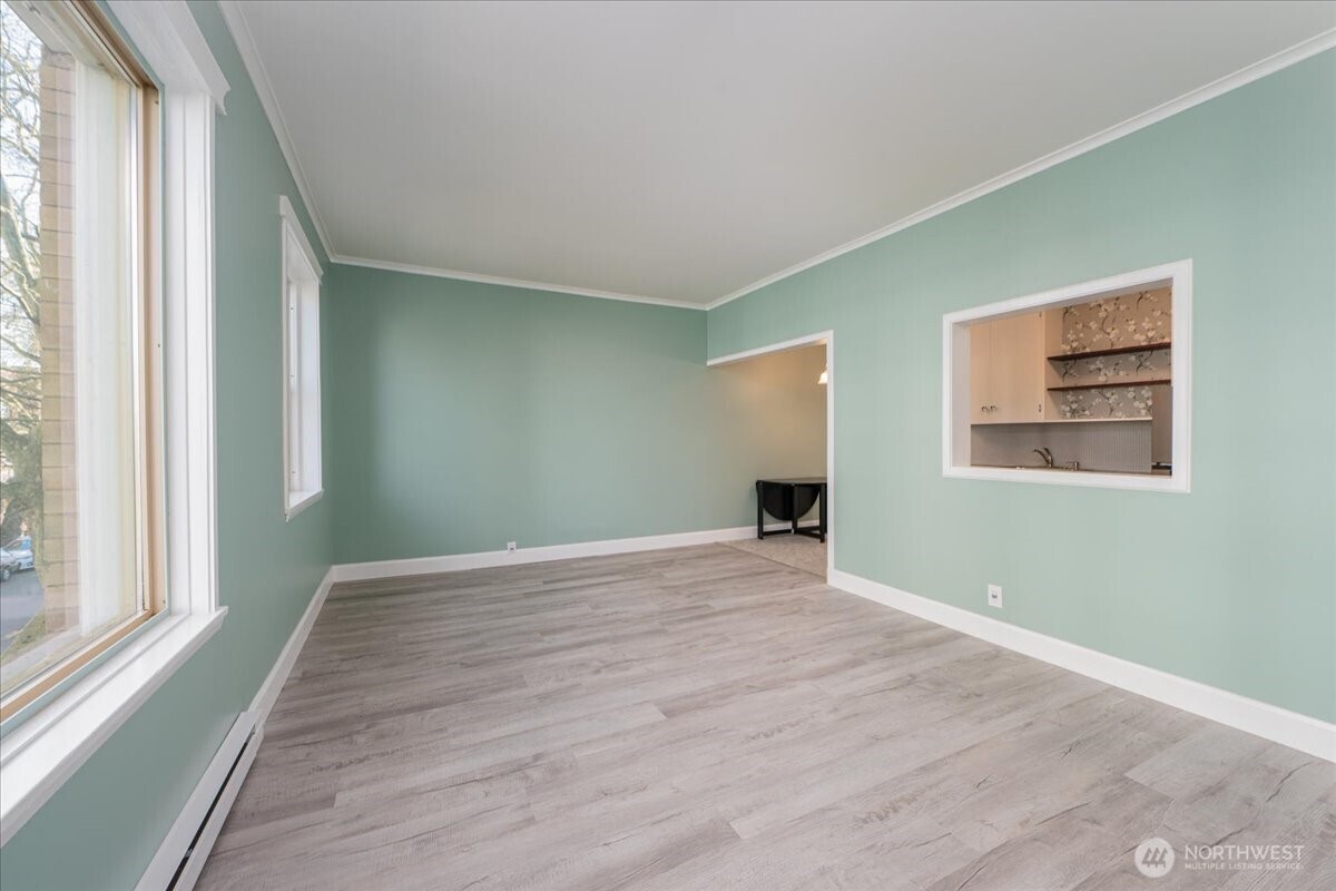 7 Harrison Street, Unit 20 Seattle, WA 98109 - Photo 5 of 27 a view of an empty room with wooden floor and a window