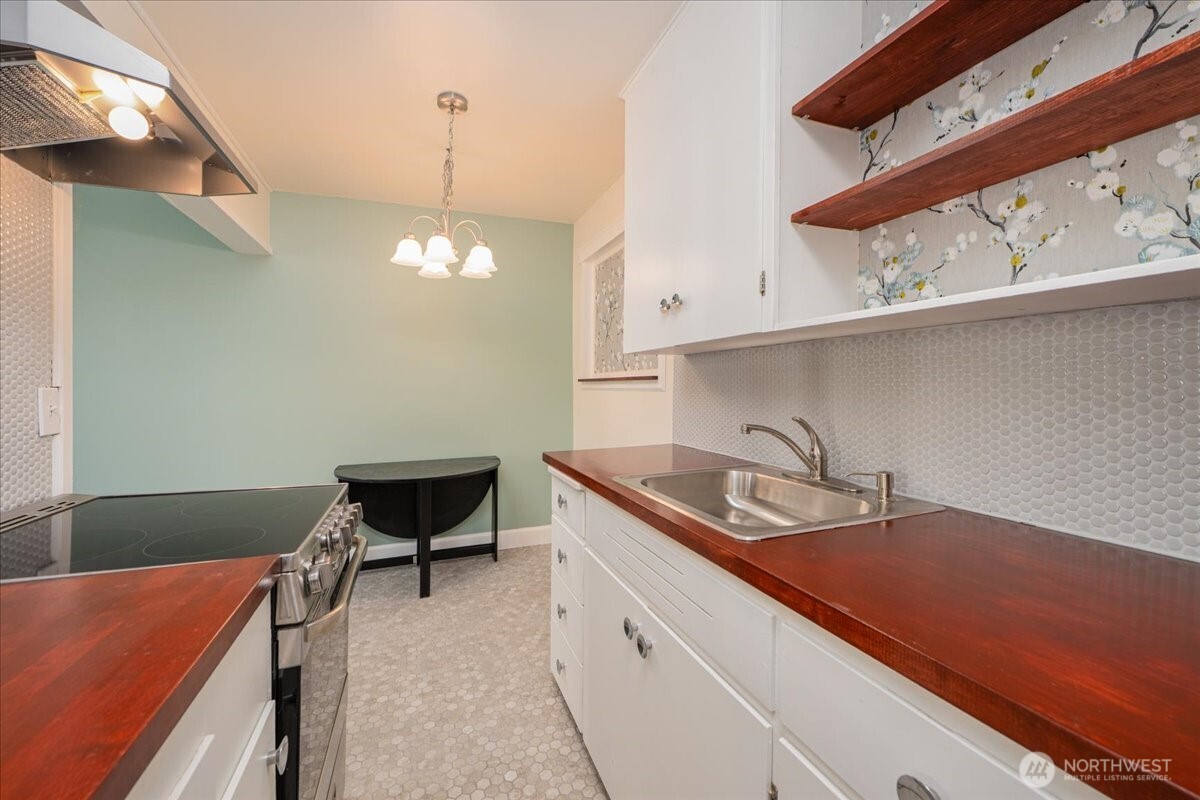 7 Harrison Street, Unit 20 Seattle, WA 98109 - Photo 10 of 27 a kitchen with a sink cabinets and a stove