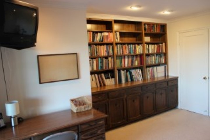 1624 Quail Ridge Road Escondido, CA 92027 - Photo 14 of 25 Photo of the den with built-in bookcases--this could be a forth bedroom by removal of the bookcase, built into the closet area (if needed). There is a sliding door to a patio area and access to the back yard and views from this room also.