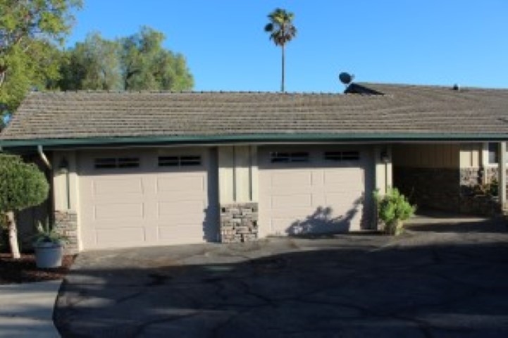 1624 Quail Ridge Road Escondido, CA 92027 - Photo 20 of 25 View from the driveway of the two one-car garages and the covered carport. The garages have separate automatic vehicle doors. They are separated by a wall and one has built in work benches--a great workshop. The other is drywalled and has lots of storage.