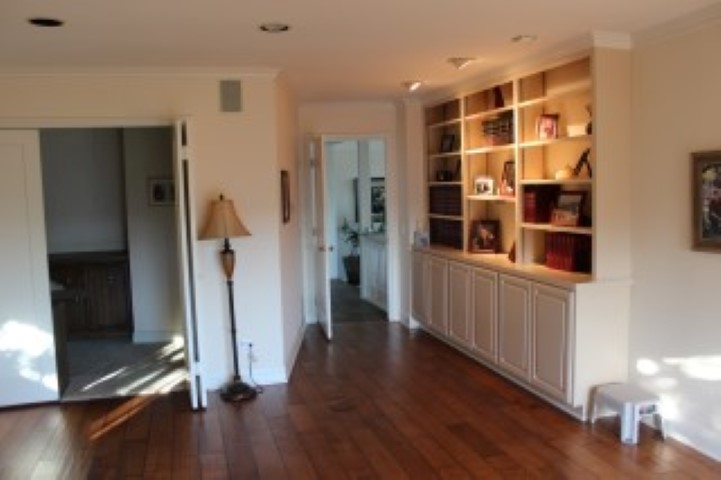 view from the family room toward the entry showing the built in bookcases and the entrance to the office, study, hobby room to the left in the photo.