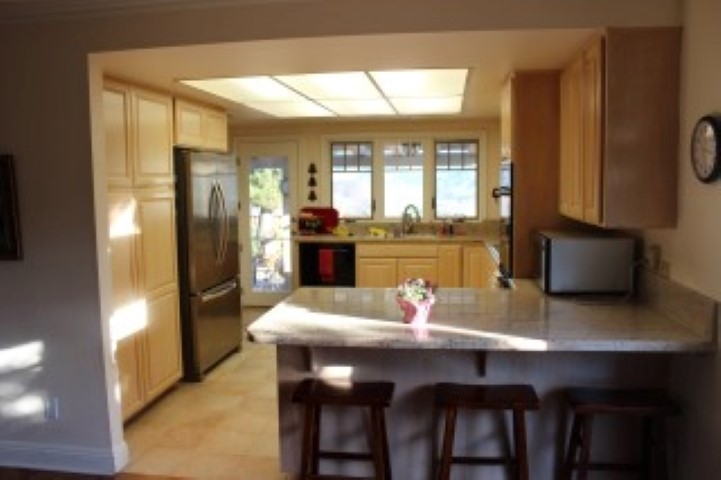 View of the kitchen and breakfast bar from the family room.