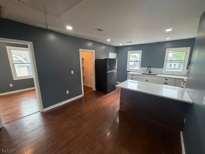 166 Renner Avenue, Unit 3 Newark, NJ 07112 - Photo 3 of 24 a large bathroom with a sink a mirror and a shower