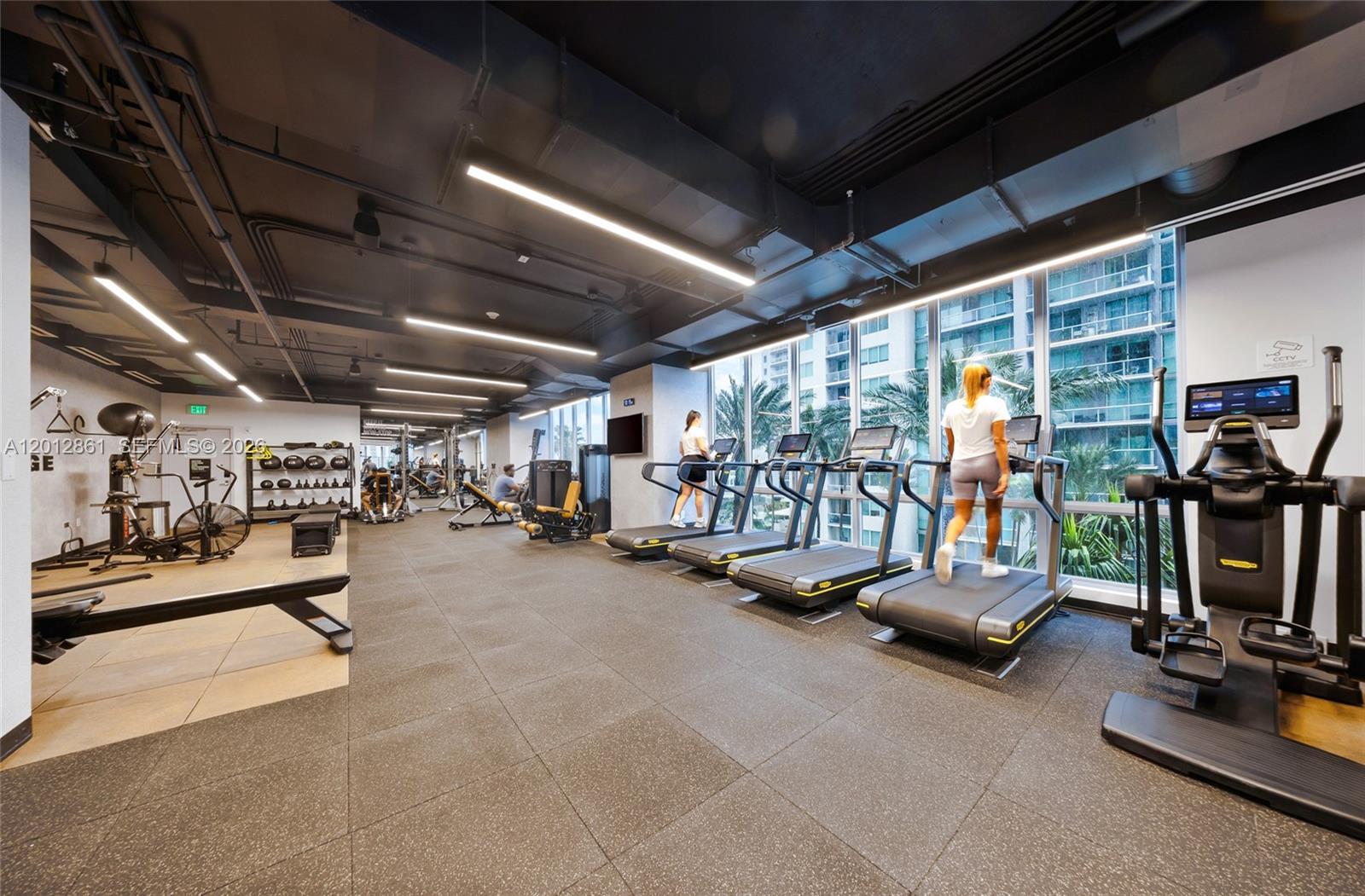 227 Northeast 2nd Street, Unit 1909 Miami, FL 33132 - Photo 17 of 18 a view of a room with gym equipment