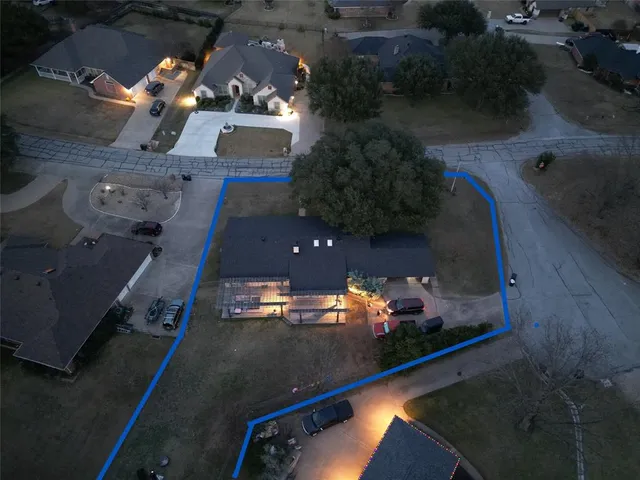 an aerial view of a house with a yard