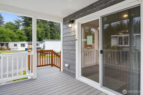 a view of a balcony with floor to ceiling window wooden floor and floor to ceiling window