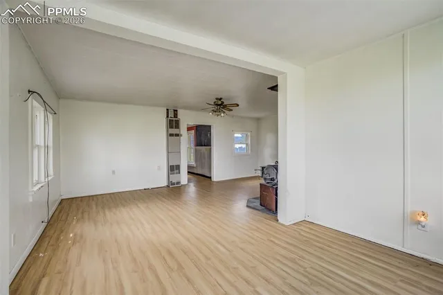 a view of a livingroom with furniture and chandelier fan