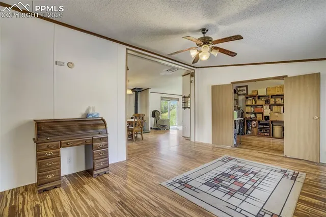 a view of a hallway with wooden floor and furniture