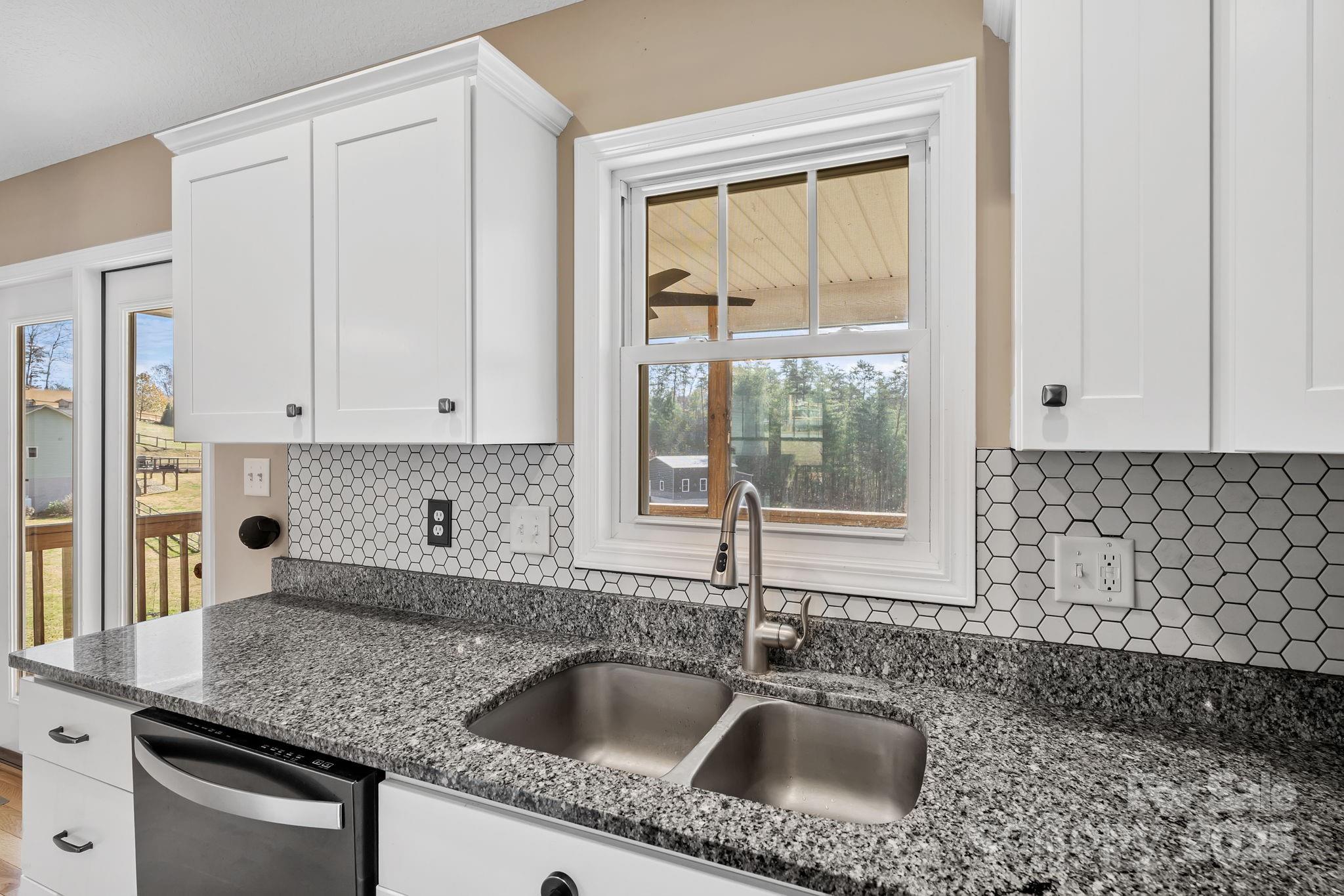 39 Curtis Miles Road Alexander, NC 28701 - Photo 13 of 37 a kitchen with granite countertop a sink and a window