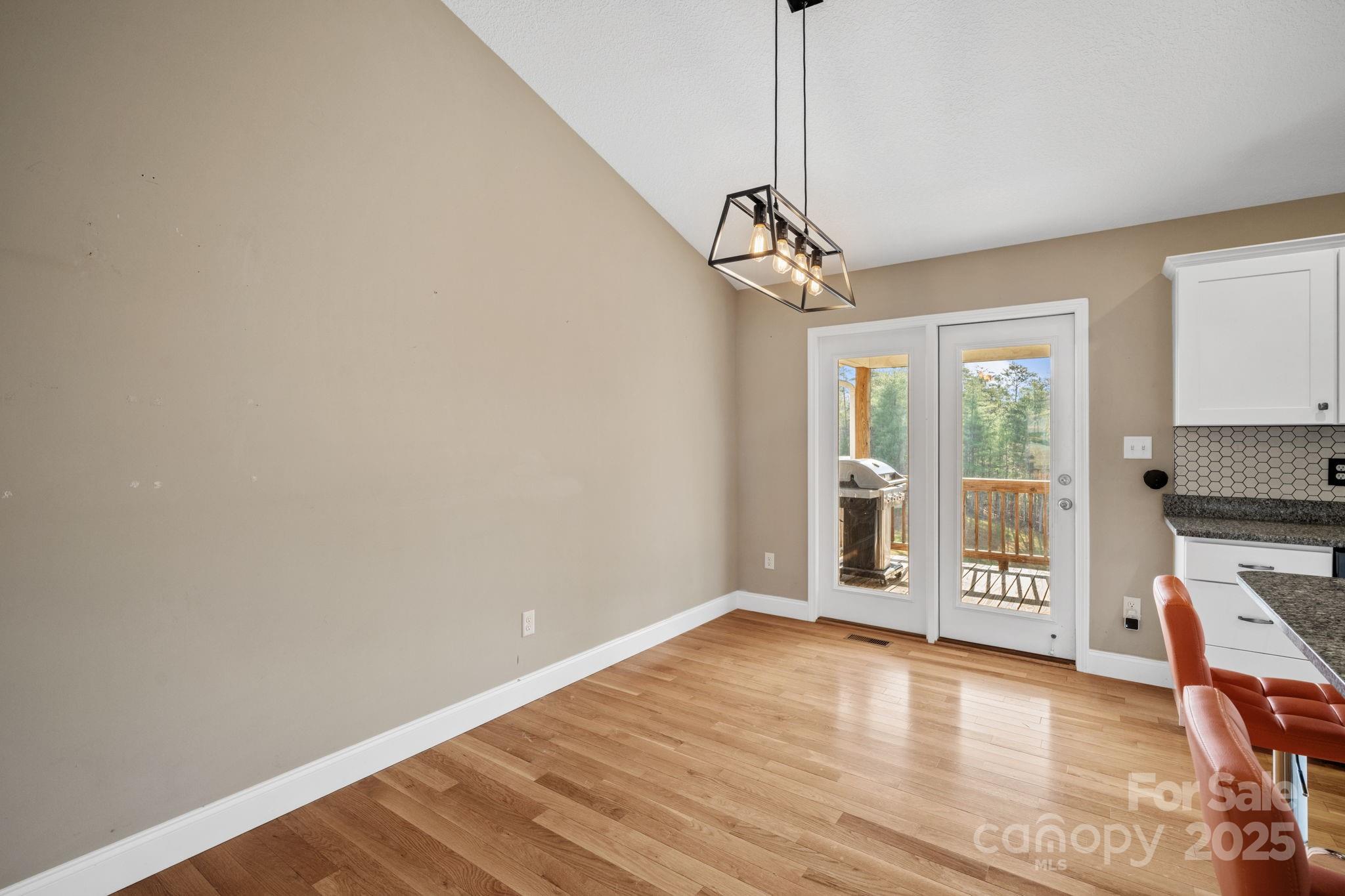 39 Curtis Miles Road Alexander, NC 28701 - Photo 15 of 37 a view of a livingroom with wooden floor a ceiling fan and windows