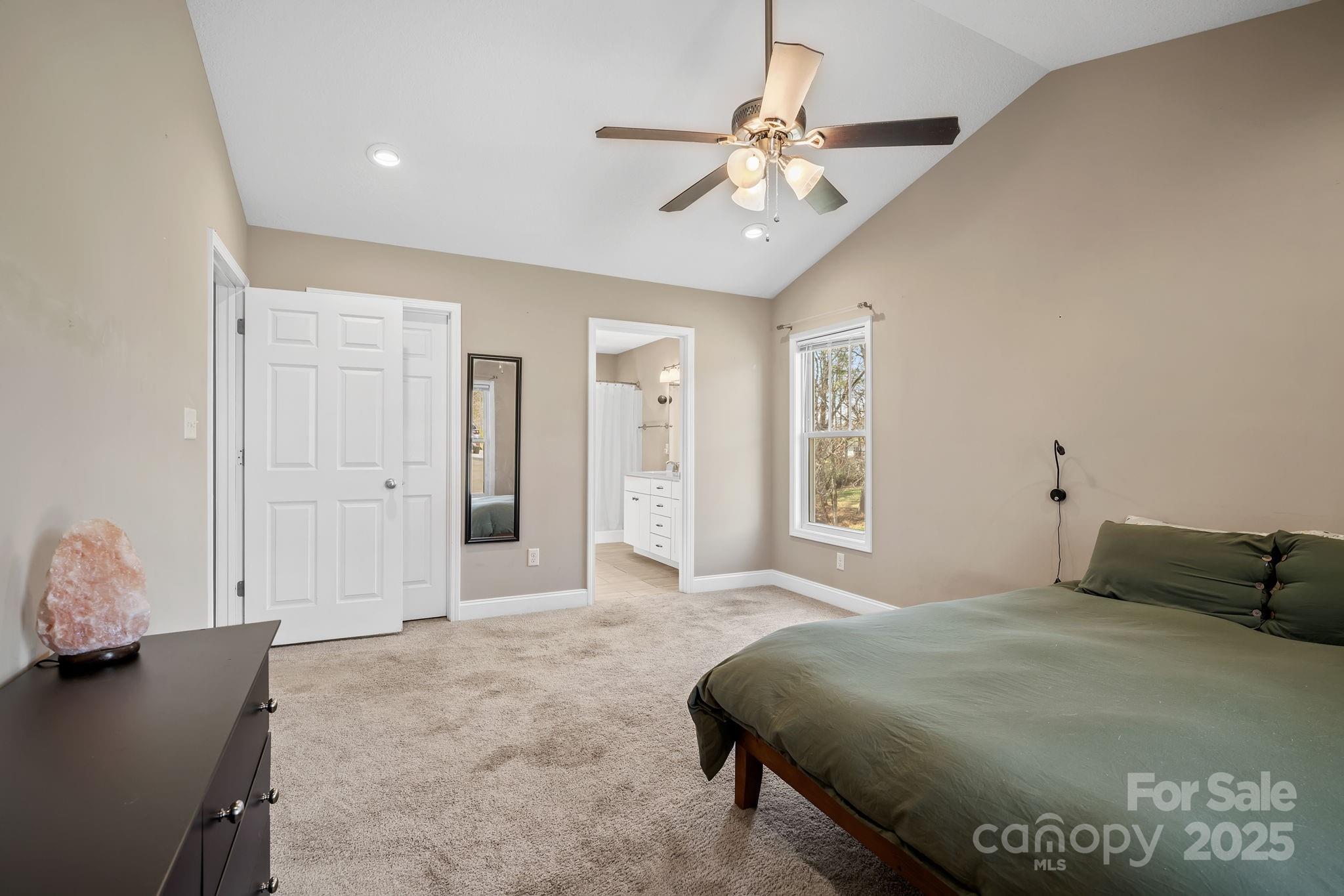 39 Curtis Miles Road Alexander, NC 28701 - Photo 19 of 37 a bedroom with a bed and a chandelier