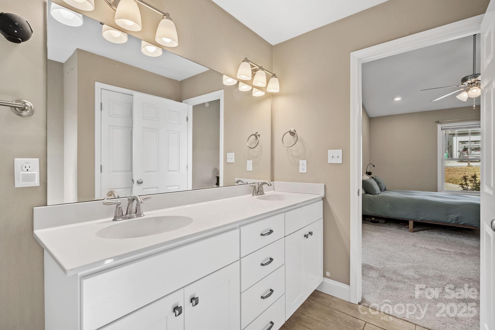 39 Curtis Miles Road Alexander, NC 28701 - Photo 21 of 37 a en suite bathroom with a double vanity sink double mirror and bathtub