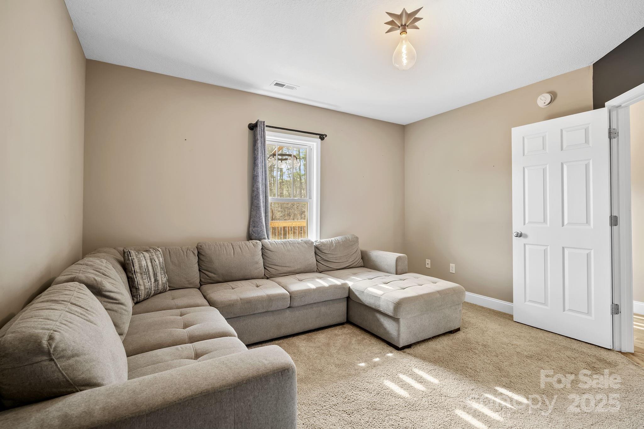 39 Curtis Miles Road Alexander, NC 28701 - Photo 24 of 37 a living room with furniture and a window