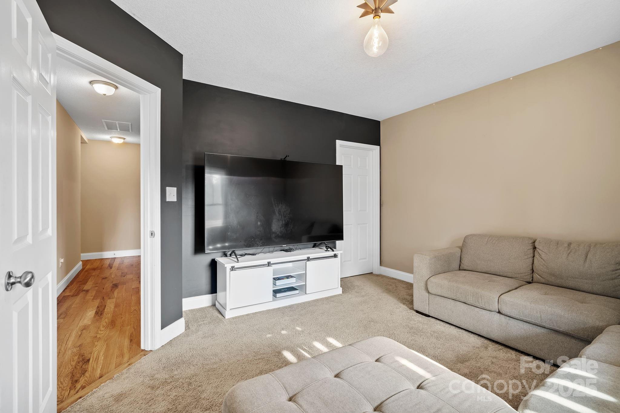 39 Curtis Miles Road Alexander, NC 28701 - Photo 25 of 37 a living room with furniture and a flat screen tv