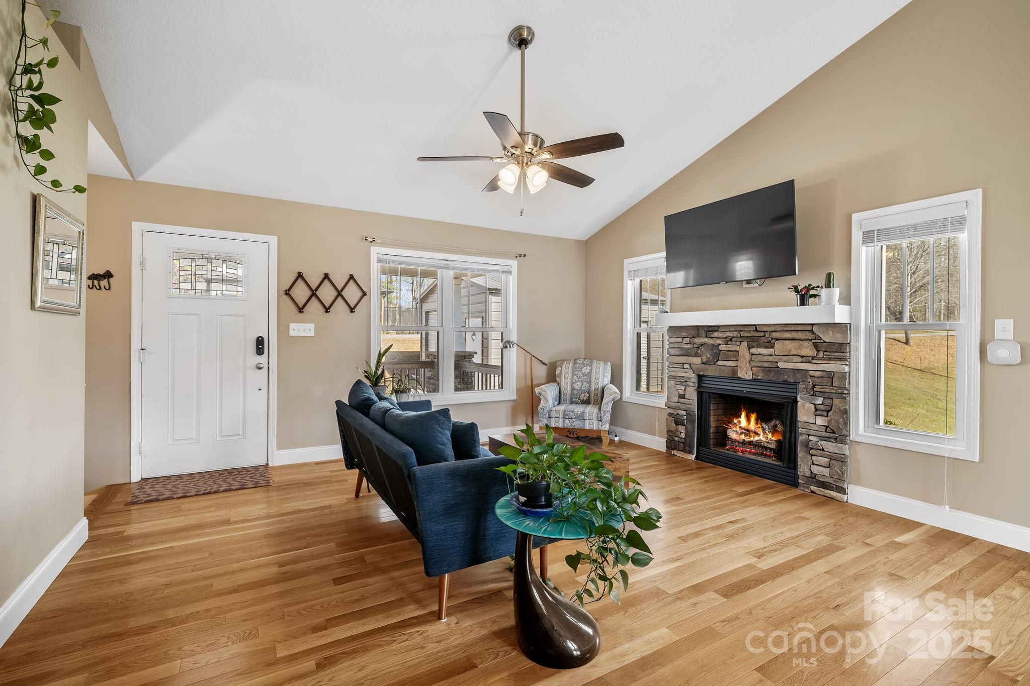 39 Curtis Miles Road Alexander, NC 28701 - Photo 6 of 37 a living room with furniture a fireplace and a flat screen tv