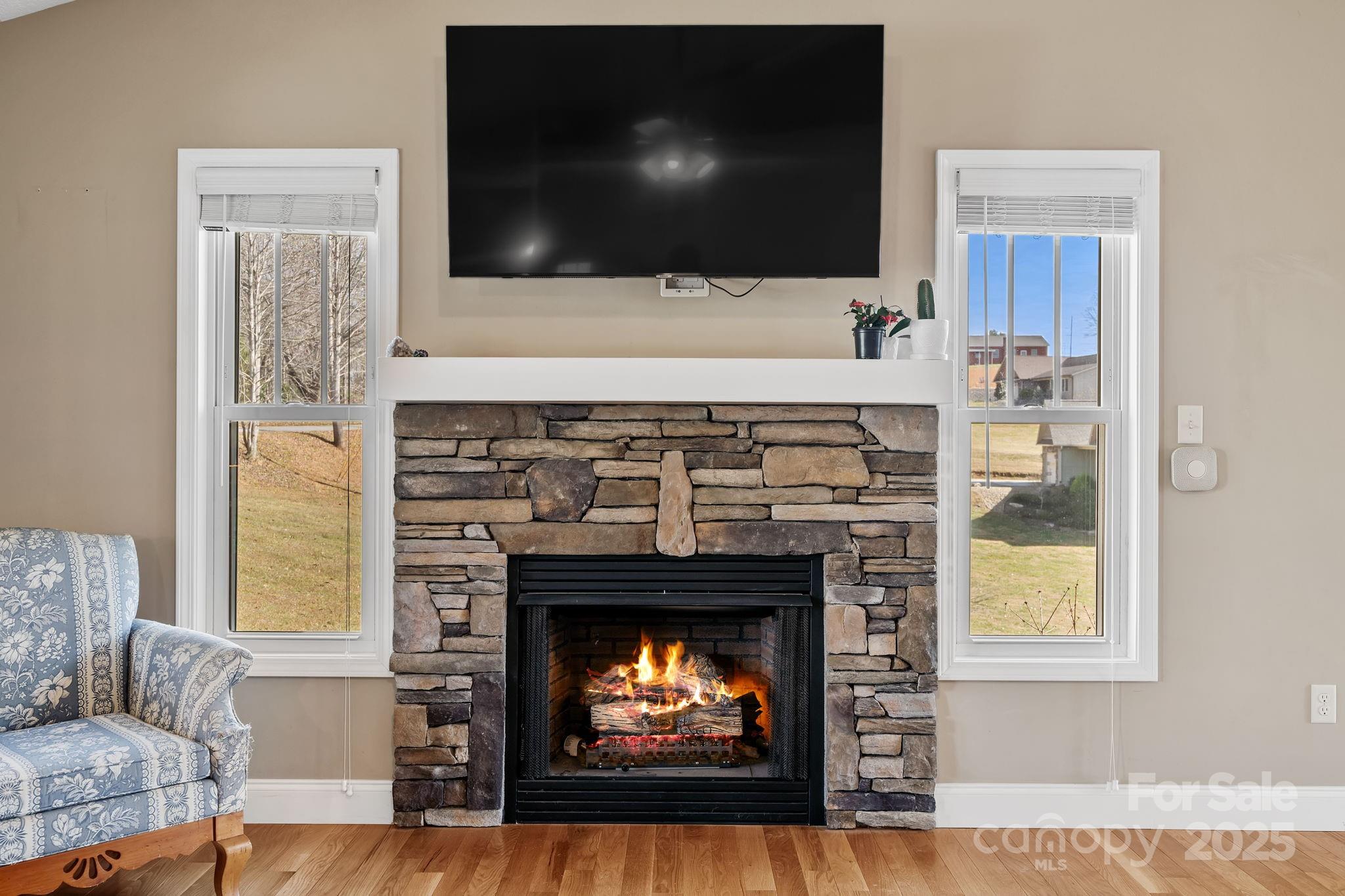 39 Curtis Miles Road Alexander, NC 28701 - Photo 9 of 37 a living room with a fireplace and a flat screen tv