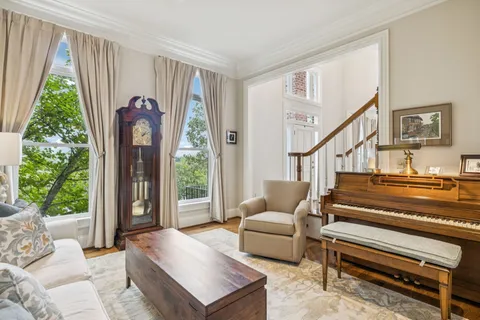 a view of a dining room with furniture wooden floor and chandelier