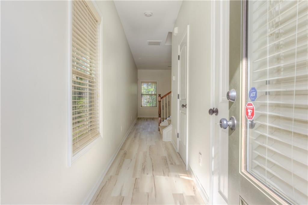 605 Summit Point Canton, GA 30114 - Photo 6 of 56 a view of a hallway with wooden floor and closet