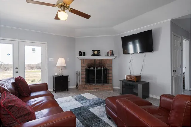 a living room with furniture a flat screen tv and a fireplace