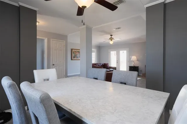 a large bedroom with a bed and a chandelier