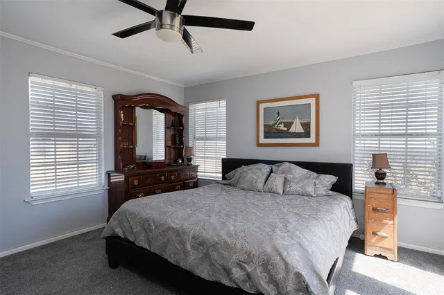 a bedroom with a large bed and a window