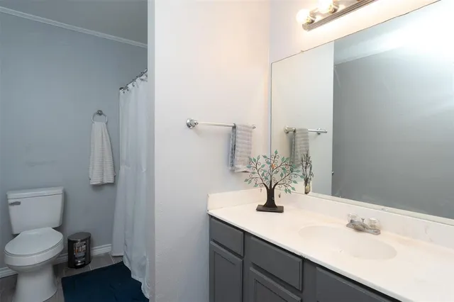 a bathroom with a sink toilet and mirror