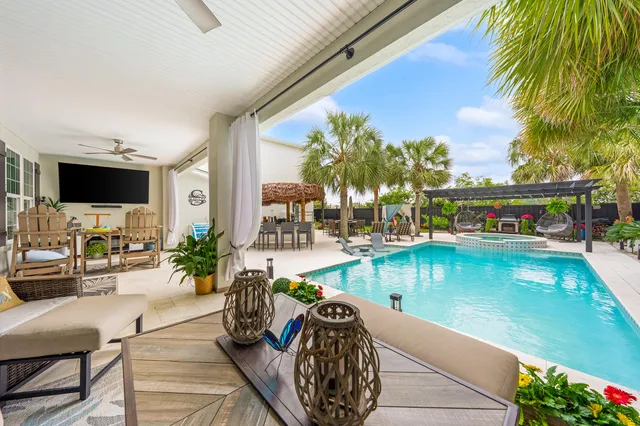 a bedroom with a bed chandelier and a window