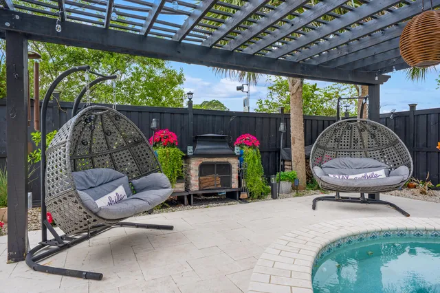 a view of a hallway with wooden floor and a potted plant