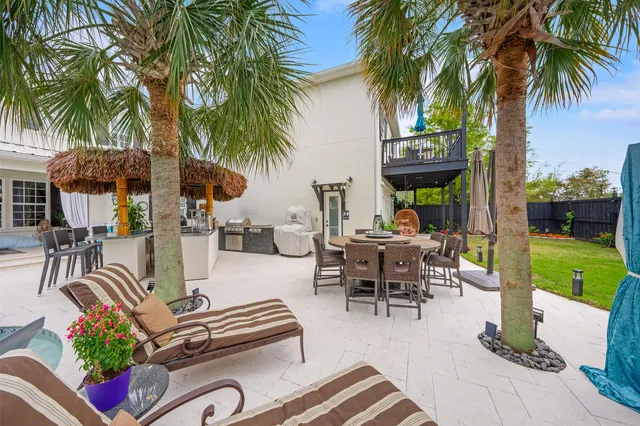 a kitchen with kitchen island granite countertop a sink stove and cabinets