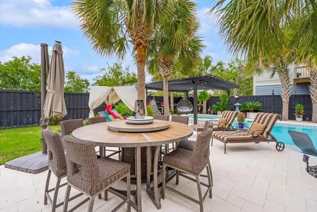 a kitchen with stainless steel appliances granite countertop a sink a stove a refrigerator wooden cabinets and floor