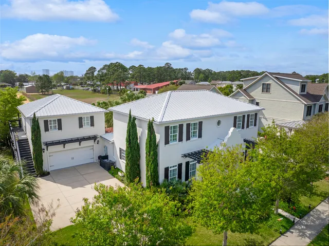 a large kitchen with lots of wooden furniture a sink a dining table and chairs