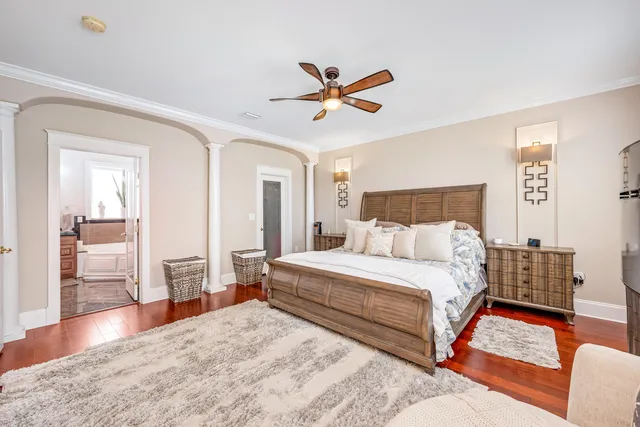 a bedroom with a bed and a chandelier