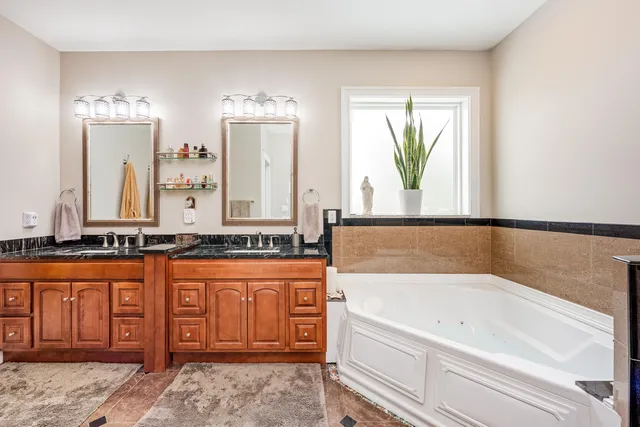 a front view of a house with a yard and potted plants