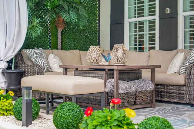 a view of swimming pool with outdoor seating and plants
