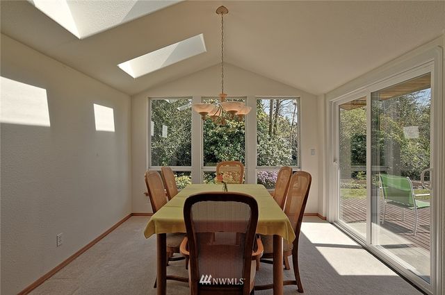 a dining room with furniture window and outside view