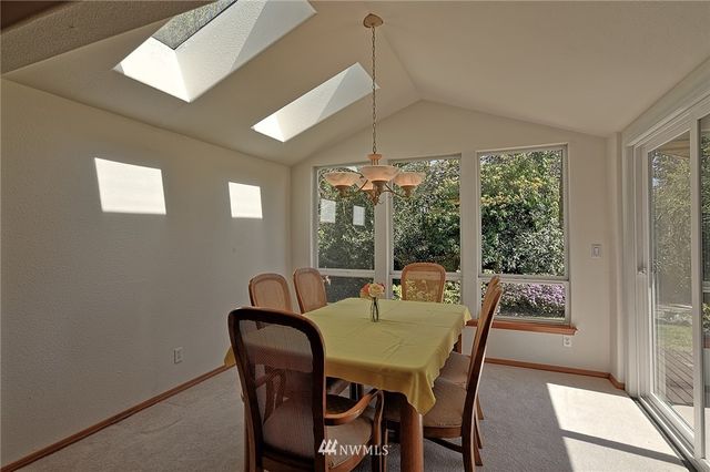 a dining room with furniture a chandelier and window