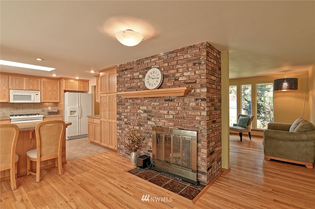 11619 31st Drive Southeast Everett, WA 98208 - Photo 15 of 30 a living room with furniture a fireplace and wooden floor