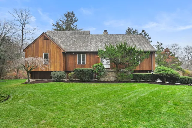 a front view of house with yard and green space