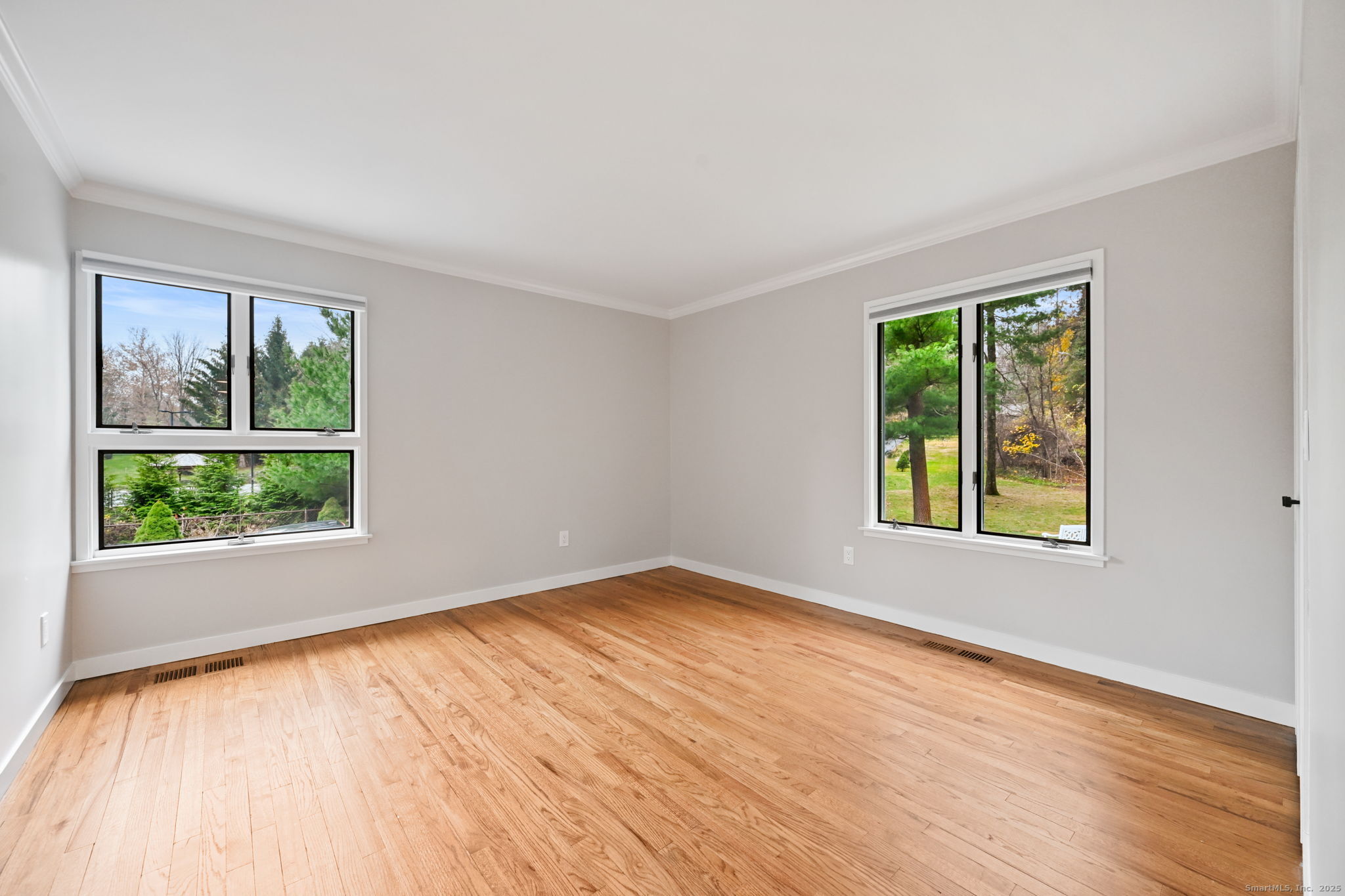 144 West Norwalk Road Norwalk, CT 06850 - Photo 13 of 29 a view of an empty room with wooden floor and a window