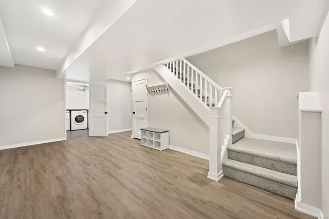 a view of entryway and hall with wooden floor