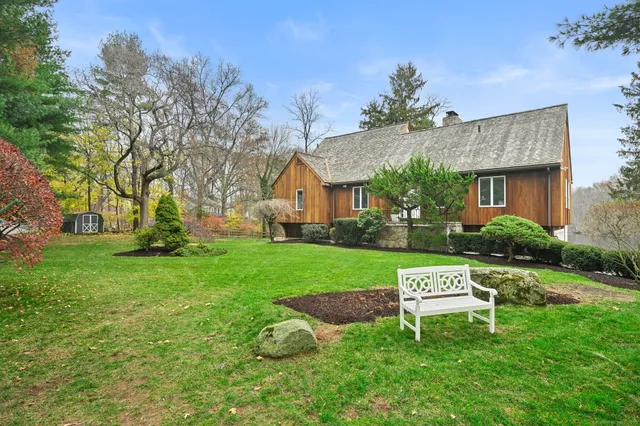a view of a house with a yard and sitting area