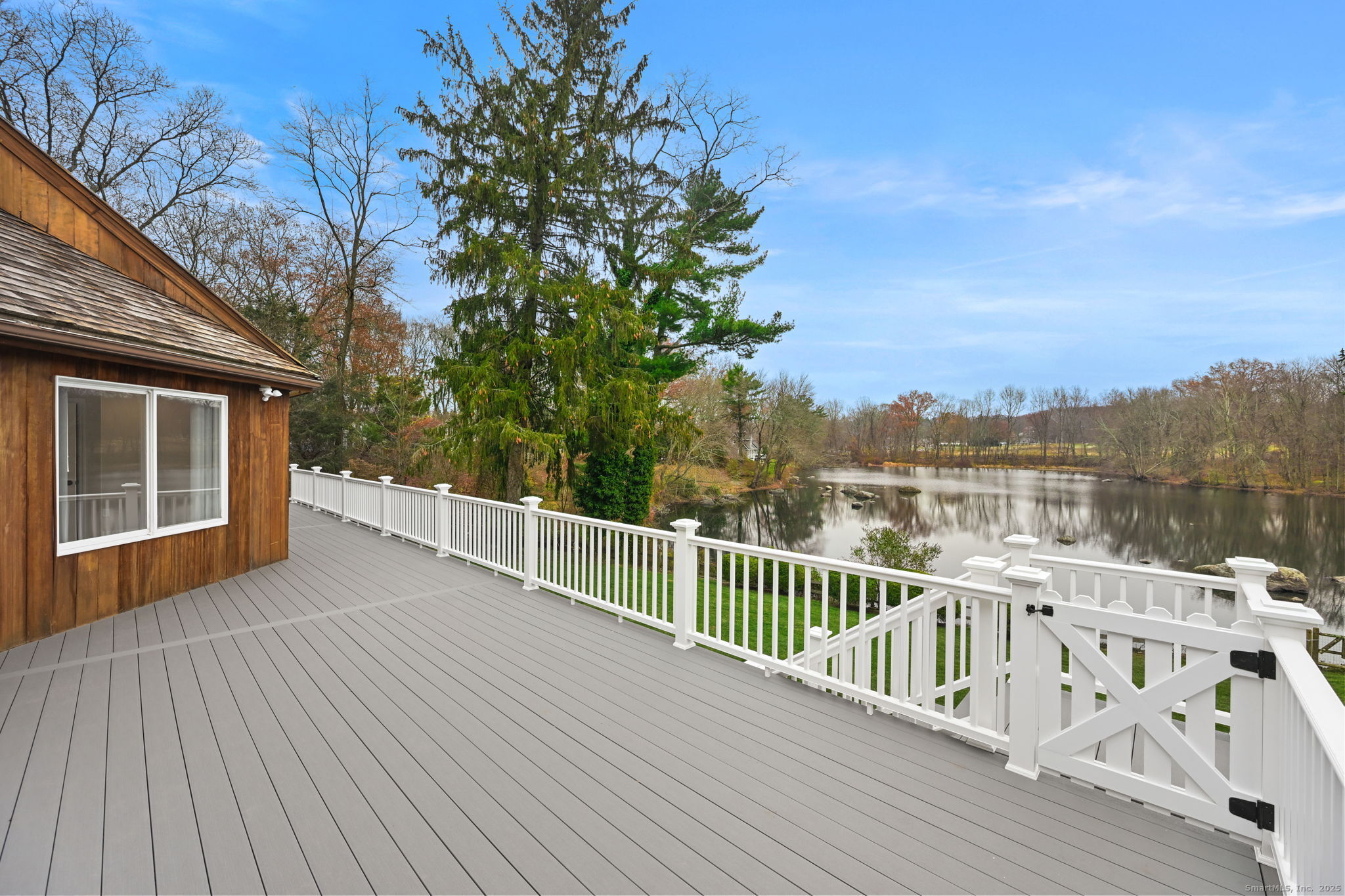 144 West Norwalk Road Norwalk, CT 06850 - Photo 23 of 29 a view of a balcony with wooden floor and fence and a trees