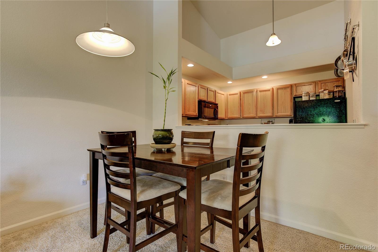 5800 Tower Road, Unit 2310 Denver, CO 80249 - Photo 8 of 29 a view of a dining room that has a table and chairs in it