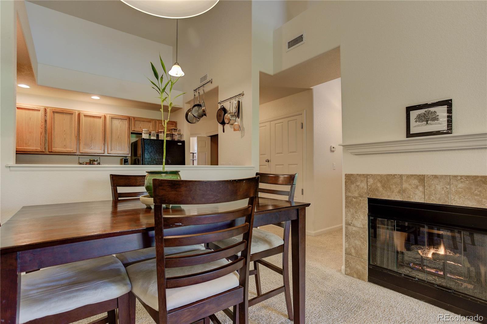 5800 Tower Road, Unit 2310 Denver, CO 80249 - Photo 9 of 29 a living room with kitchen furniture and a fireplace