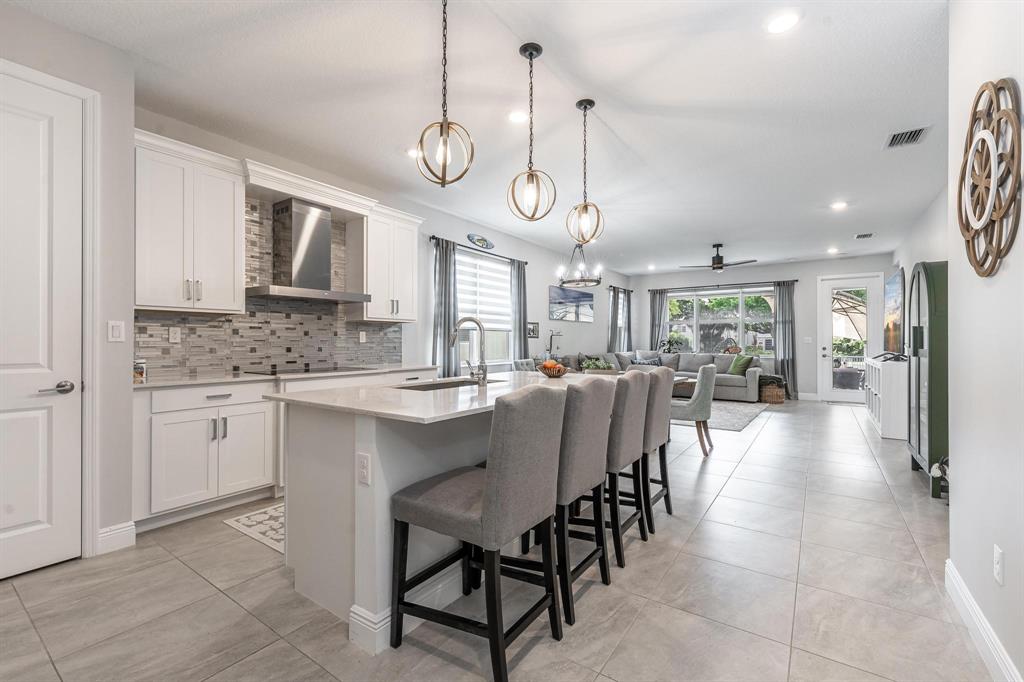 4185 Marina Way Deerfield Beach, FL 33064 - Photo 12 of 40 a large kitchen with a table and chairs