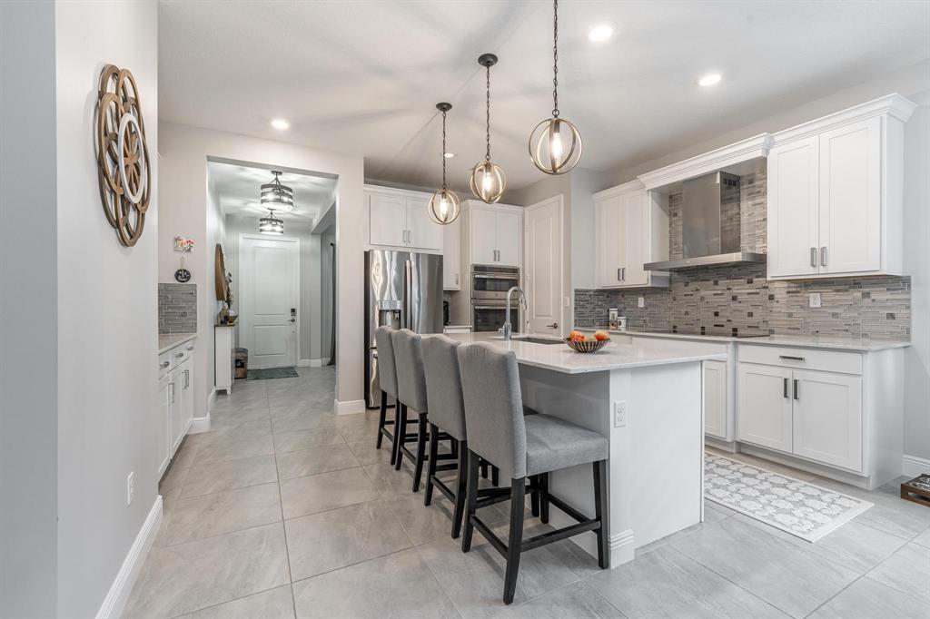 4185 Marina Way Deerfield Beach, FL 33064 - Photo 13 of 40 a kitchen with stainless steel appliances kitchen island granite countertop a table chairs sink and cabinets