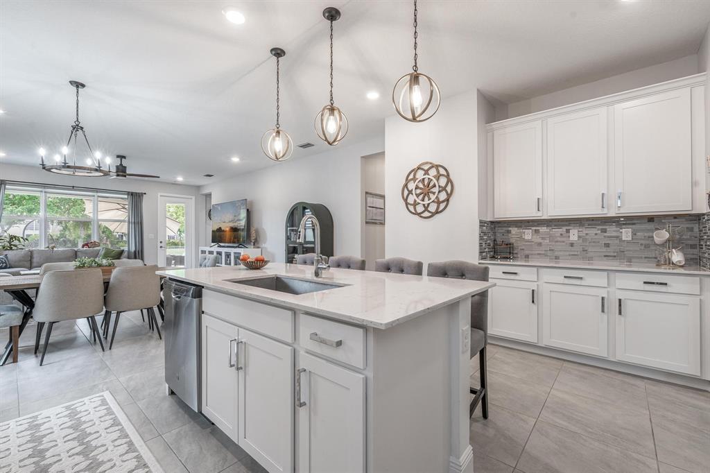 4185 Marina Way Deerfield Beach, FL 33064 - Photo 15 of 40 a kitchen with a sink cabinets and a clock